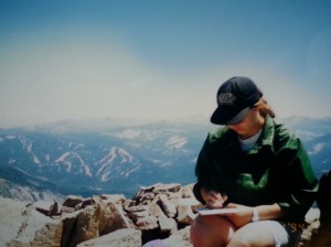 Me atop Pyramid Peak in August 1994.  I am writing the note that I will place in a film canister and bury near the summit.